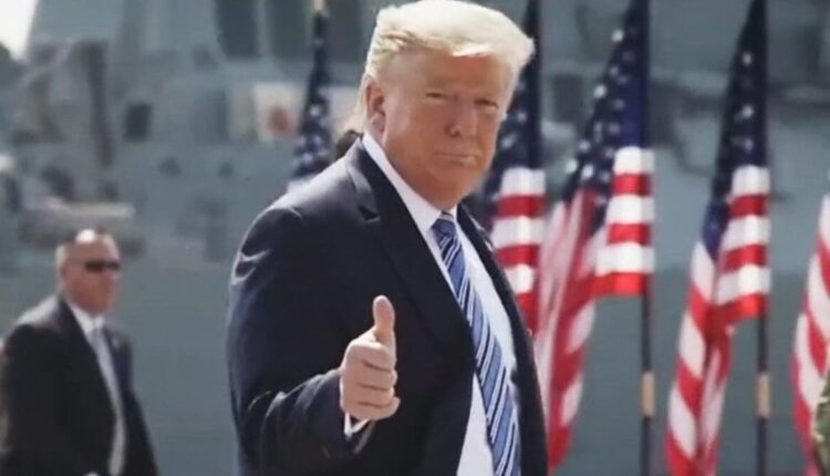 Trump thumbs up smile flags 1200x630.jpg