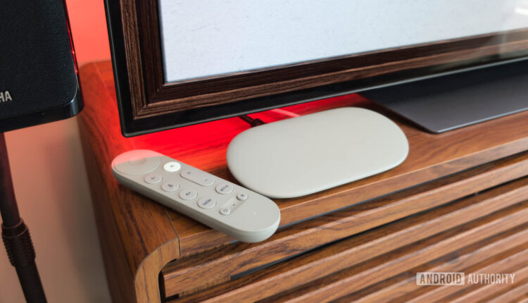 Google TV Streamer with Remote on TV console with red light.jpg