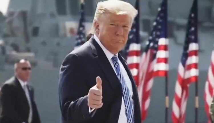 Trump thumbs up smile flags 1200x630.jpg