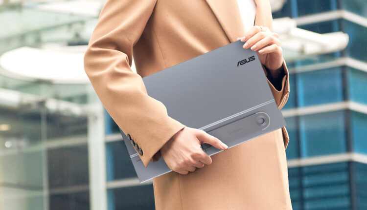 Person in suit with ASUS ZenScreen 16 OLED MQ16AHE portable monitor.jpg