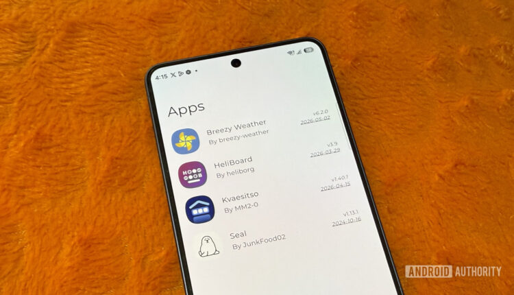 Samsung phone on an orange pillow showing a list of apps scaled.jpg
