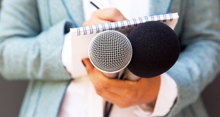 Microphone notebook interview wellphoto adobe.jpg