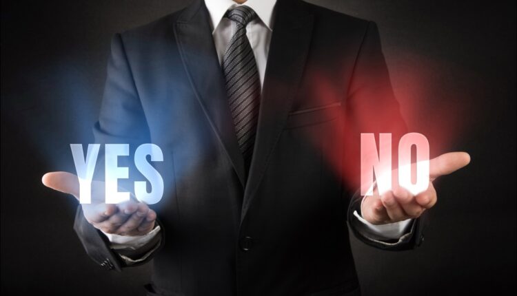 Man holding Yes and No voting decision election 08.17.26 Getty 2225561570.jpg