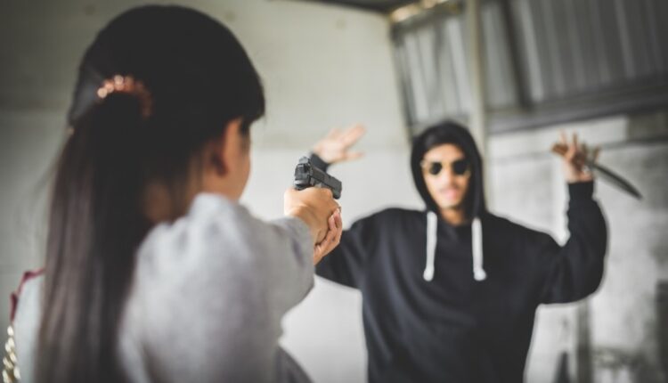 Girl defending self with gun resized 09.05.26 Getty 901792426.jpg